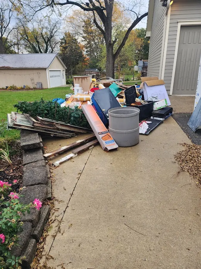 Dumpster being loaded with debris for 10 Yard Dumpster Rental in Belpre